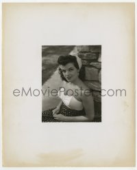 8g462 JANE RUSSELL 8.25x10 still 1940s wearing low-cut blouse & scarf in hair by stone wall!