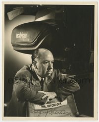 8p369 ALFRED HITCHCOCK signed deluxe 8x10 still 1950s w/ his director chair & camera by Bud Fraker!