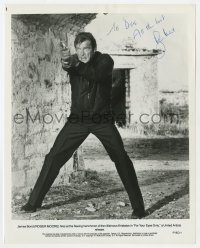 8p623 ROGER MOORE signed 8x10.25 still 1981 full-length as James Bond w/ gun in For Your Eyes Only!