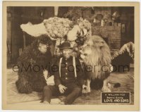 9k613 LOVE & LIONS LC 1925 guy on floor by fake ape, real lion & man in bird suit!