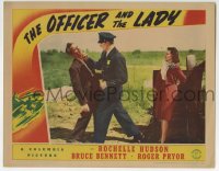 9k691 OFFICER & THE LADY LC 1941 Bruce Bennett saves Rochelle Hudson by knocking out bad guy!