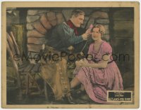 1a715 OUTLAWS OF RED RIVER LC 1927 c/u of cowboy Tom Mix putting flower in Marjorie Daw's hair!