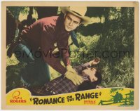 1a793 ROMANCE ON THE RANGE LC 1942 close up of Roy Rogers examining unconscious man on the ground!