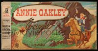 1h339 ANNIE OAKLEY red title style board game 1957 cowgirl Gail Davis is forced to fight!