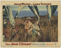 1k794 SEA CHASE LC #1 1955 John Wayne & Lana Turner walking through high grass on an island!