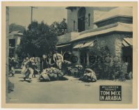 1k898 TOM MIX IN ARABIA LC 1922 Tom Mix leaps over a camel as he runs from Arabian guys in village!