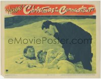 3z0652 CHRISTMAS IN CONNECTICUT LC 1945 Barbara Stanwyck & Dennis Morgan laying in snow, Gardiner!