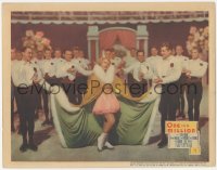 3z1070 ONE IN A MILLION LC 1936 ice skater Sonja Henie wearing cape, surrounded by handsome men!