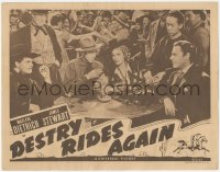 5k0981 DESTRY RIDES AGAIN LC R1947 Marlene Dietrich & James Stewart drinking in crowded saloon!