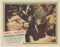 5k1291 NOTHING SACRED LC R1944 Fredric March & Carole Lombard watching intense wrestling match!