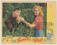 5k1468 SWEATER GIRL LC 1942 uniformed Eddie Bracken behind bush kissing June Preisser's finger!