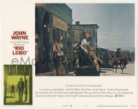 6c0659 RIO LOBO LC #8 1971 Howard Hawks, close up of John Wayne riding through town on horseback!