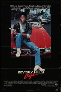 6h0654 BEVERLY HILLS COP 1sh 1984 great image of detective Eddie Murphy sitting on red Mercedes!