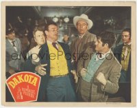 7r1004 DAKOTA LC 1945 big John Wayne is restrained as another guy reels back to punch him!