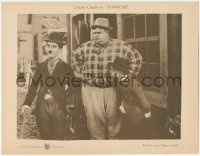 7r1478 SUNNYSIDE LC R1920s Charlie Chaplin in Tramp suit by a very large man & a very small man!
