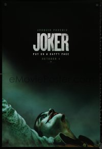 8a0943 JOKER teaser DS 1sh 2019 close-up image of clown Joaquin Phoenix, put on a happy face!