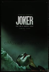 8a0942 JOKER int'l teaser DS 1sh 2019 close-up image of clown Joaquin Phoenix, put on a happy face!