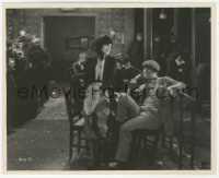 8k0063 BLACKBIRD 7.75x9.75 still 1926 seated Lon Chaney Sr. stares at Doris Lloyd sitting on table!