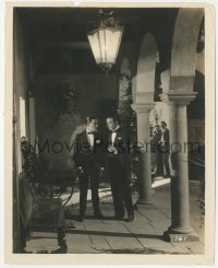 8k0374 SAINTED DEVIL 8x10 still 1925 Rudolph Valentino speaking with another man in a dark corner!