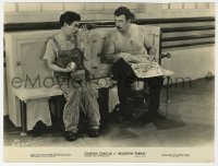 8k0294 MODERN TIMES deluxe 7x9.25 still 1936 Charlie Chaplin staring at big guy with big lunch box!