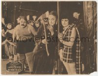 8k0793 BETWEEN THE ACTS LC 1919 strongman glares at Larry Semon holding axe & flirting with girl!