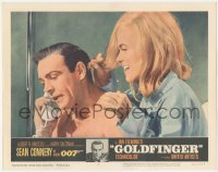 8k0927 GOLDFINGER LC #2 1964 c/u of sexy Shirley Eaton behind Sean Connery as James Bond on phone!