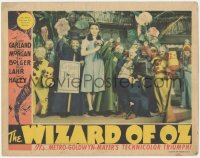 8k1297 WIZARD OF OZ LC 1939 Judy Garland with Munchkins & coroner, The Wicked Witch is dead, rare!