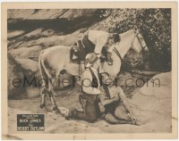 8z0994 DESERT OUTLAW LC 1924 Buck Jones leans down from his horse to help wounded man on ground!