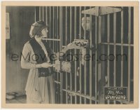 8z1449 UP & GOING LC 1922 pretty Eva Novak brings food to cowboy Tom Mix in his jail cell!