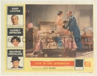 9j0817 LOVE IN THE AFTERNOON LC 1957 Audrey Hepburn sitting on packed suitcase by Gary Cooper!