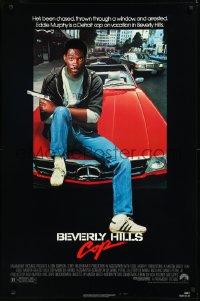 9z1236 BEVERLY HILLS COP 1sh 1984 great image of detective Eddie Murphy sitting on red Mercedes!
