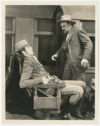 2b1882 TEXAN 8x10.25 still 1930 seated cowboy Gary Cooper draws his gun as man approaches him!