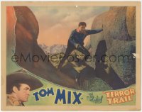 2b1360 TERROR TRAIL LC 1933 great close up of Tom Mix standing on rocks with his gun drawn!