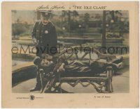 2f1293 IDLE CLASS LC 1921 great image of cop about to whack Tramp Charlie Chaplin asleep on bench!