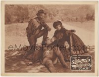 2p1237 DEADWOOD COACH LC 1924 two people help cowboy Tom Mix, who has just regained consciousness!
