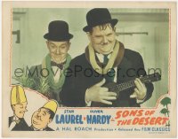 2p1434 SONS OF THE DESERT LC R1945 best close image of Stan Laurel & Oliver Hardy w/leis & ukulele!