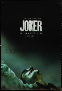 2w0984 JOKER teaser DS 1sh 2019 close-up image of clown Joaquin Phoenix, put on a happy face!