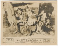 4b1287 CUPID'S ROUNDUP 8x10 LC 1918 Tom Mix & pretty Wanda Hawley sitting between two trees, rare!