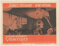 4f0587 VERTIGO LC #8 1958 Alfred Hitchcock, standing James Stewart glares at blonde Kim Novak!