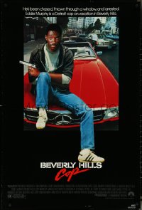 6g0773 BEVERLY HILLS COP 1sh 1984 great image of detective Eddie Murphy sitting on red Mercedes!