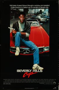 6k0574 BEVERLY HILLS COP 1sh 1984 great image of detective Eddie Murphy sitting on red Mercedes!